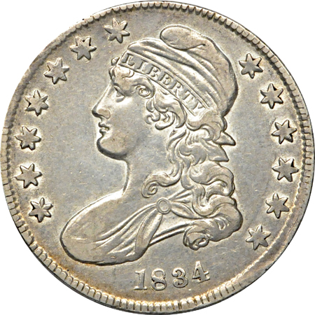 Four half-dollar type coins.