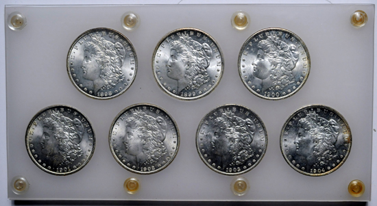 Seven O Mint (1898-O - 1904-O) Morgan dollars in plastic holder.