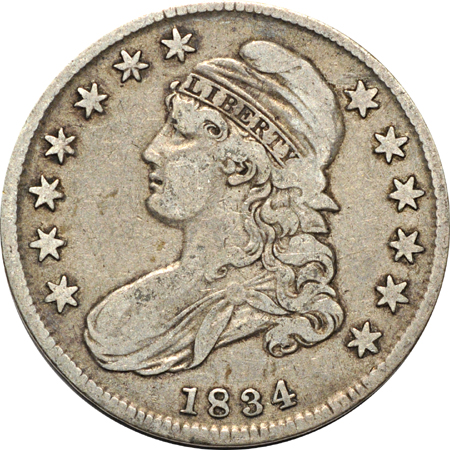 Four Capped Bust half-dollars.