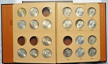 Three partially filled albums of Morgan dollars.