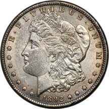 1876-S Trade dollar AU details/cleaned, and an 1892-CC Morgan dollar AU details.