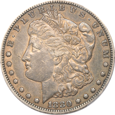 Four PCGS certified Morgan dollars.