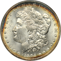 Group of four silver dollars in older slabs.